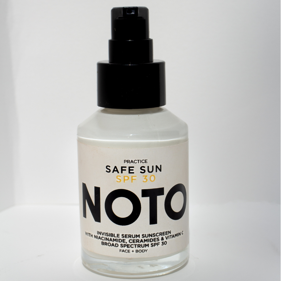 Bottle of Noto sunscreen spray on a white background
